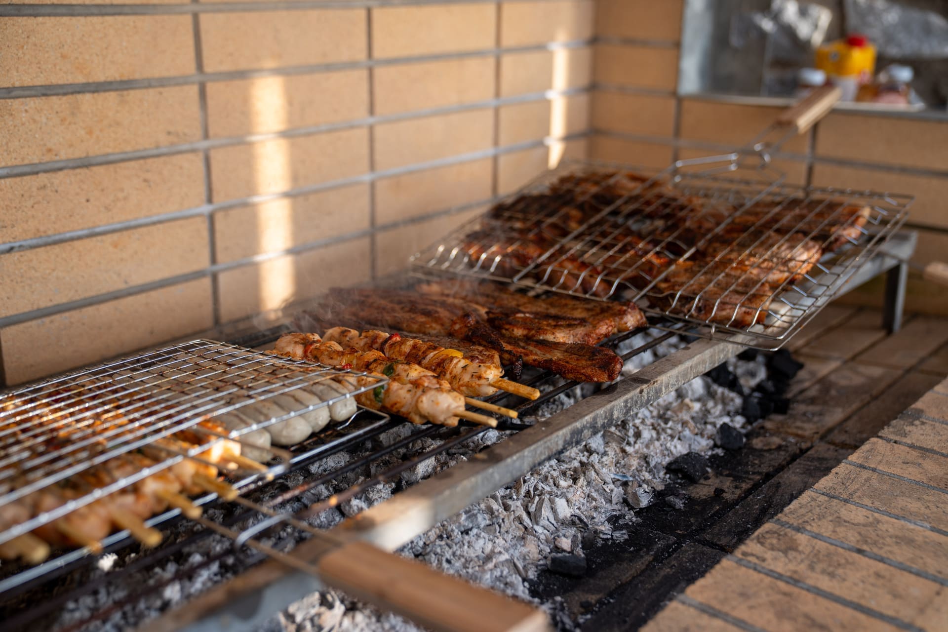 BBQ grill with souvlaki skewers over charcoal at the BBQ Endless View, Secret Oasis