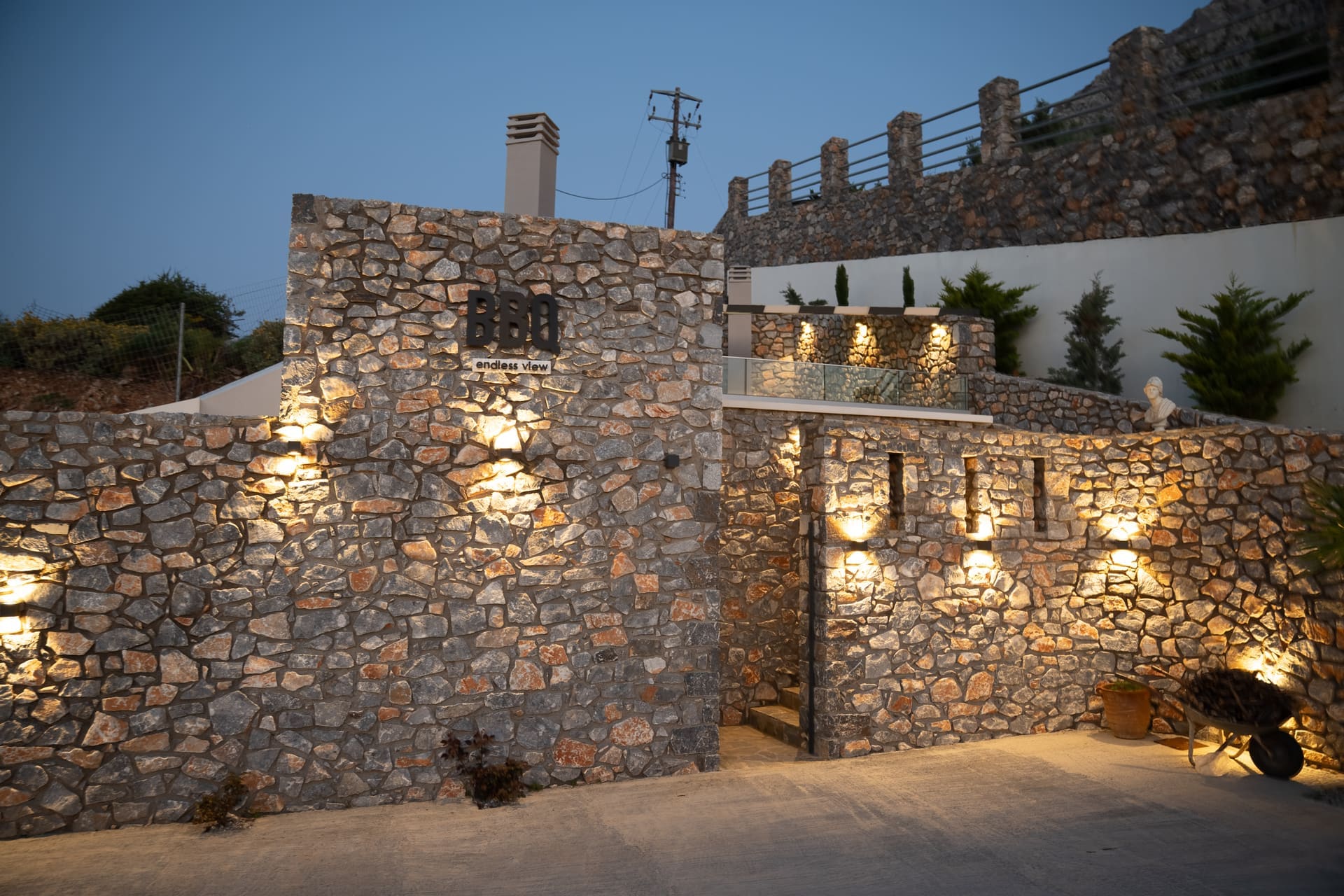 BBQ Endless View venue at night with illuminated stone walls, Secret Oasis Plakias Crete